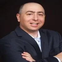 Steven_Mostyn from Featured seen crossing his hands and seen in black color suit